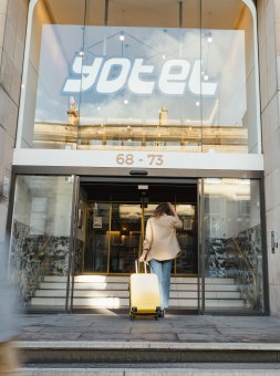 Exterior of YOTEL Edinburgh. People walking by. 